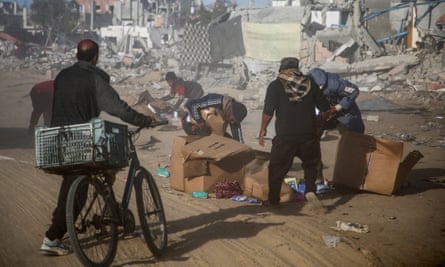 Palestinians rush to grab boxes that fell from aid trucks in Rafah