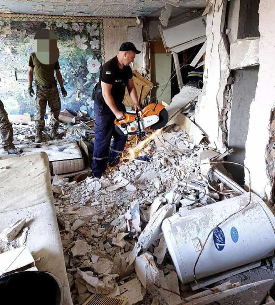 Russia-Ukraine war: two children among 18 dead after missile strike on Odesa; Zelenskiy hails ‘significant’ Snake Island victory – live 2 In this photo provided by the Ukrainian emergency services, first responders work on a damaged residential building in Odesa.