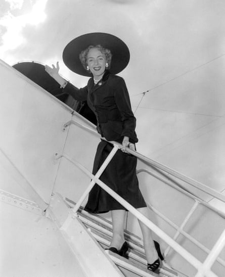 Christine Jorgensen waves from an ocean liner before sailing from New York to Denmark.