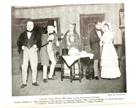 Six actors stand on a theatre stage in Victorian costumes