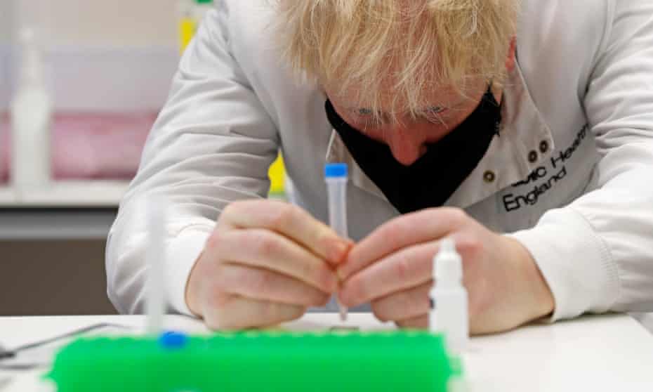 Boris Johnson examines a sample during a visit to Porton Down science park, near Salisbury.
