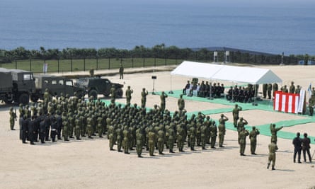 Members of Japan’s self defence force hold an opening ceremony of a new military base on the island of Yonaguni in 2016