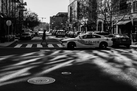 Police block a city street with their cars.