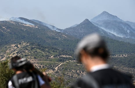 Smoke rising from a mountain forest.