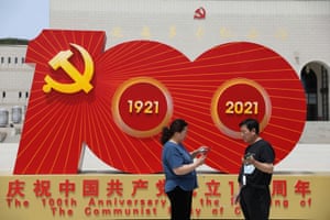 Visitors stand in front of an installation marking the 100th founding anniversary of the Communist Party of China at Yanan Revolution Memorial Hall