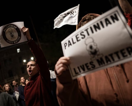 Protesters in Jerusalem shout and hold 'Palestinian Lives Matter' signs at a night rally