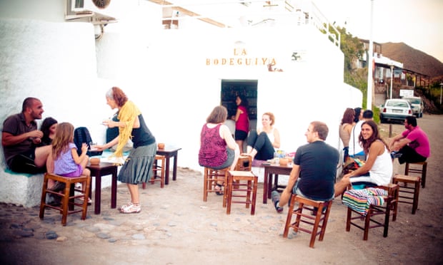 People outside a very typical, old-fashioned, whitewashed chringuito in las Negras, Cabo de Gata, Almeria, Andalucia