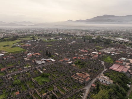 An aerial shot of Pompeii with Vesuvius in the far right