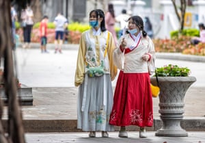 Women in traditional Chinese dress walk in the park in Guangzhou, Guangdong province, China, on May 1, 2020.