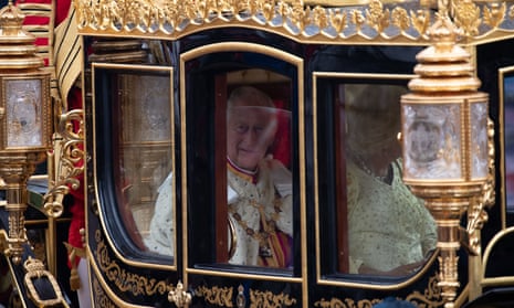 King Charles III and Queen Camilla are carried in the diamond jubilee state coach.