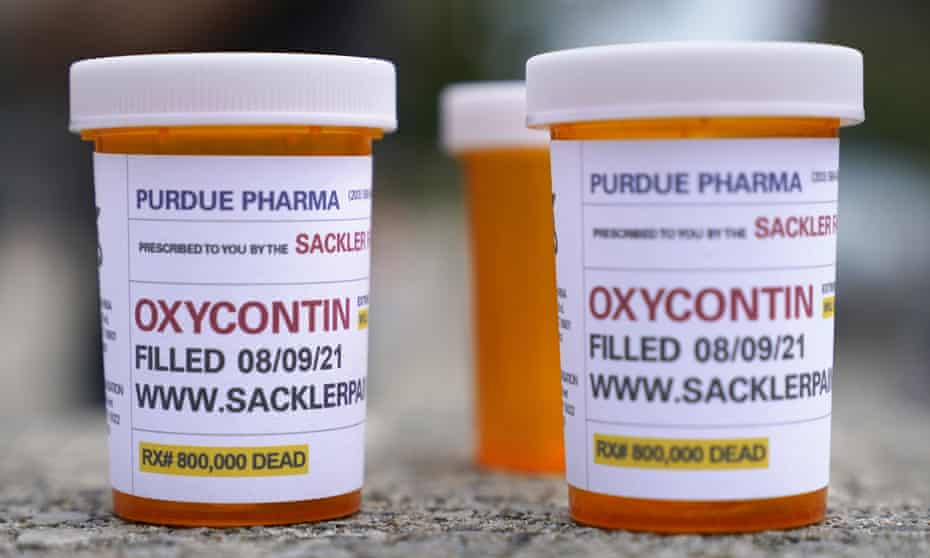Fake pill bottles with messages about Purdue Pharma printed on the labels.