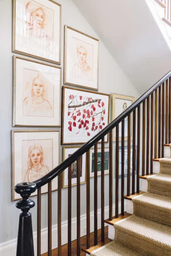 A gallery wall of family portraits along a stairway wall