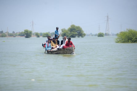 A boat carries flood people to land in Sindh, Pakistan, on 2 September 2022.
