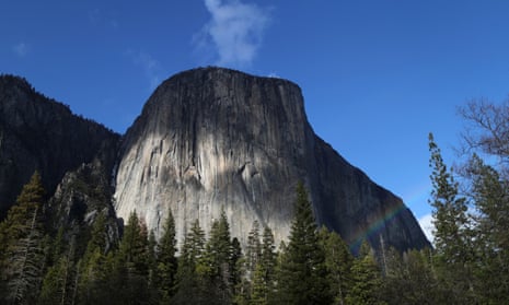 A rainbow is seen across the Yosemite Valley in front of El Capitan granite rock formation in Yosemite national park.