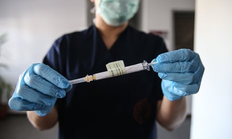 A health care worker holds a syringe of Pfizer vaccine trial against coronavirus at the Ankara University Ibni Sina Hospital in Turkey on October 27, 2020.