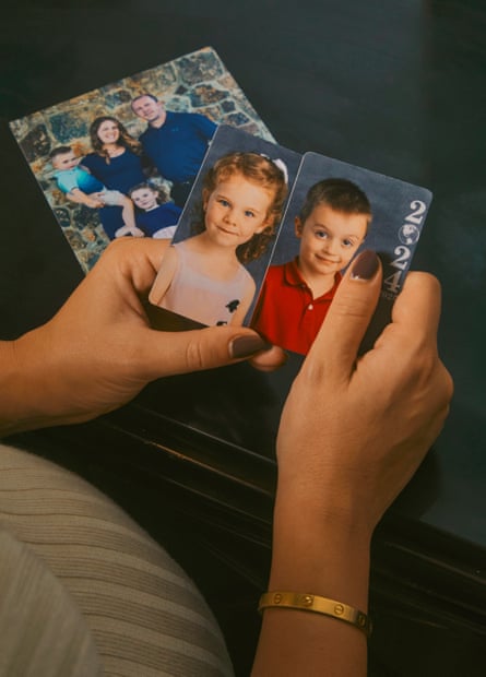 hands holding two magnets featuring a boy and a girl. A magnet in the background features a family portrait