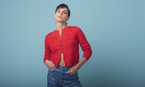 Model in red cardigan and jeans