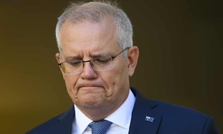 A close up of Scott Morrison's face. He is looking down and frowning