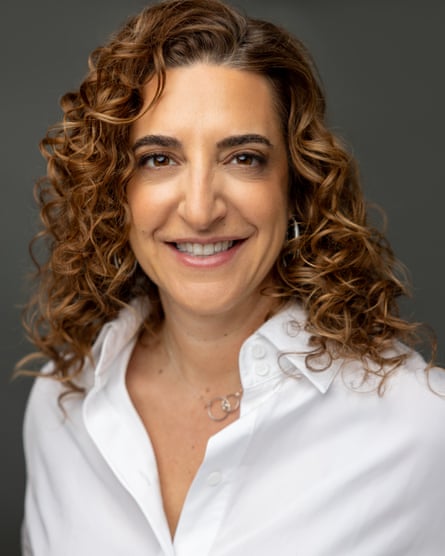 she is in her mid-40s and has long, curly light brown hair.