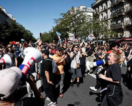 People with loudhailers and flags amid a street march