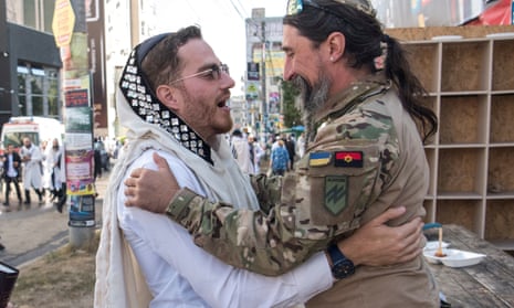 In Uman Ukraine's National Guard Brigade 'Azov' service member with the call sign 'Rabbi' embraces with Ultra-Orthodox Jewish pilgrim during a celebration of the Rosh Hashanah holiday, the Jewish New Year.