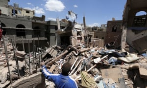 Yemenis stand over the rubble of houses destroyed by a Saudi-led airstrike on Sana’a, Yemen, in September 2015.