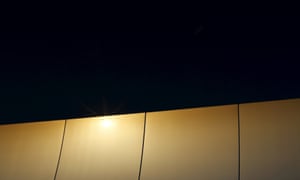 The sun reflects off a solar collector assembly at the Andasol solar power station, southern Spain. Retroactive changes to funding rules have caused disputes and cutbacks in several countries, notably Spain.
