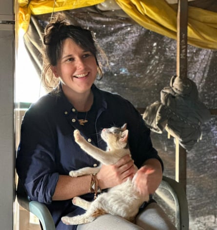 Bethan McKernan smiling, with a cat in her lap