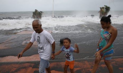 People walk along a flooded seafront after the passage of Hurricane Maria in Basse-Terre, Guadeloupe island, France, September 19, 2017. REUTERS/Andres Martinez Casares