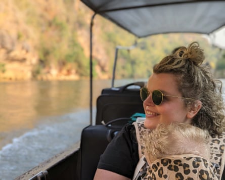 Rose Stokes in a boat with her child in a baby carrier