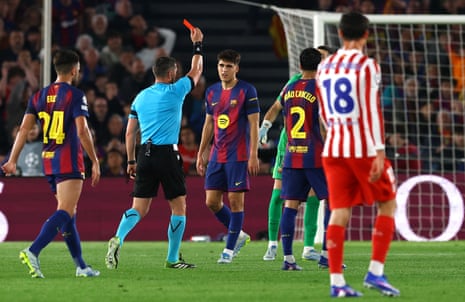 Barcelona's Pau Cubarsi is shown a red card by referee Istvan Kovacs.