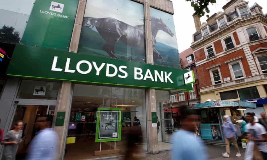 People walk past a branch of Lloyds Bank on Oxford Street in London 