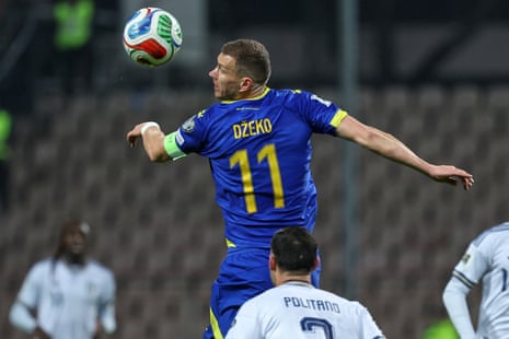 Bosnia’s Edin Dzeko heads the ball during the World Cup qualifying playoff match between Bosnia and Italy