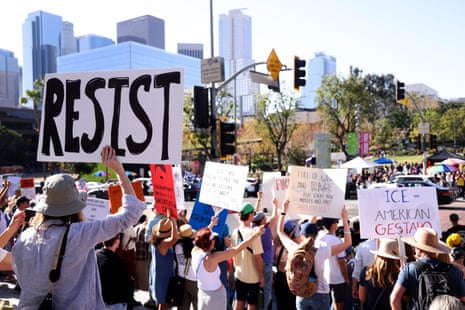 people hold signs at a protest