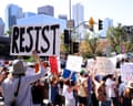 people hold signs at a protest