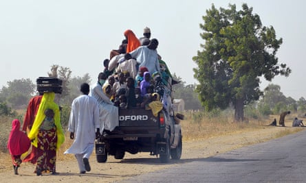 People flee after Boko Haram attacks on Mairi village, on the outskirts of Maiduguri in Borno