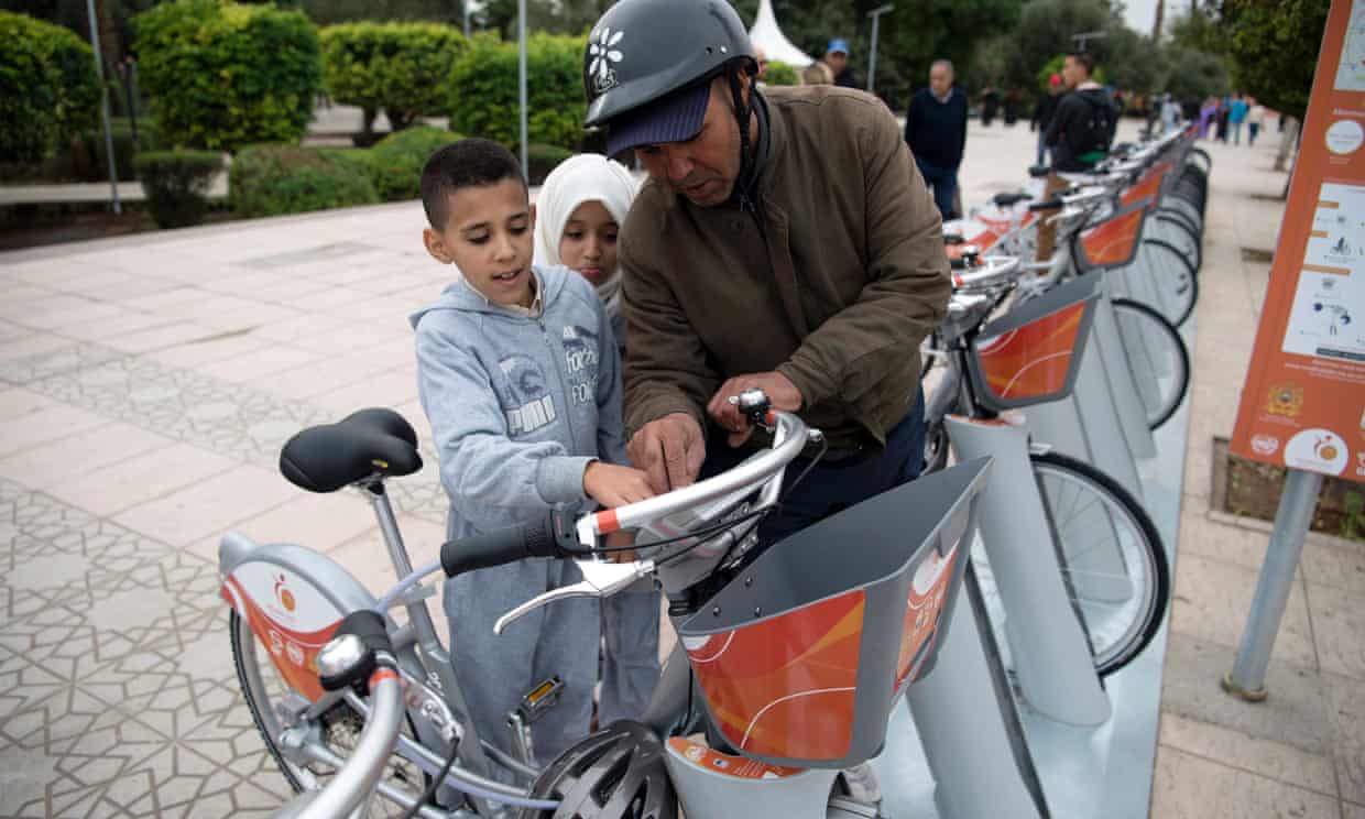 A man and his children inspect the recently installed ‘Medina Bike’ scheme in Marrakech, launched to coincide with the COP22 UN climate talks.