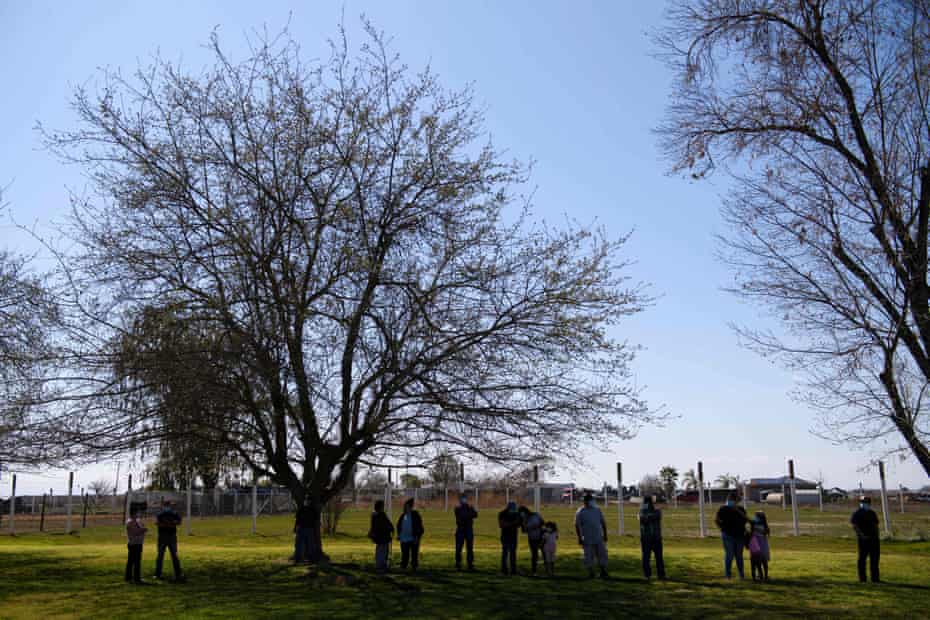 People wait in line to make an appointment to receive doses of the Johnson &amp; Johnson and Pfizer Covid-19 vaccines at a vaccination site inside Reuther Hall at Forty Acres in Delano, California, this week.