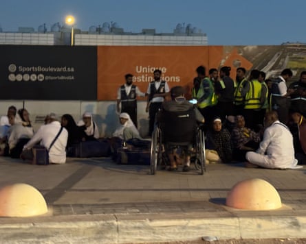 People standing in a group and others sitting on the ground