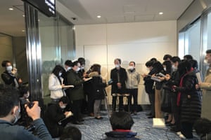 Takeo Aoyama, center left, and Takayuki Kato, center right, speak to media after landing in Tokyo Takeo Aoyama, center left, and Takayuki Kato, center right, speak to media after landing in Tokyo