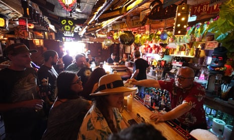 People enjoy tropical cocktails in the tiny interior of the Tiki-Ti bar on Sunset Boulevard in Los Angeles.
