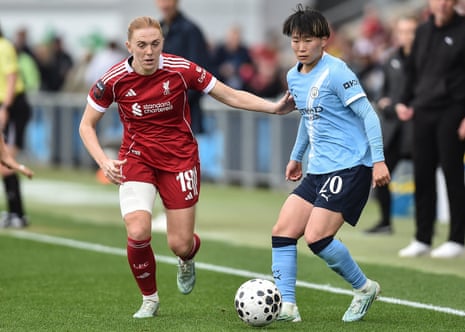 Aoba Fujino under pressure from Liverpool's Welsh midfielder Ceri Holland.