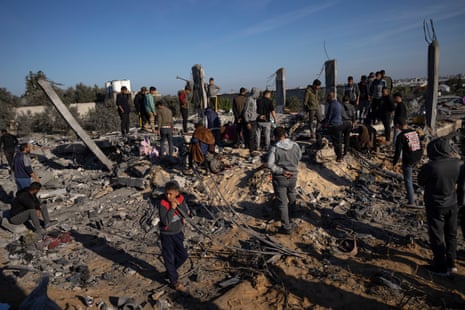Palestinians search for bodies and survivors in the rubble of a house destroyed in an Israeli airstrike in Rafah, in the southern Gaza Strip, one of the areas the population has been ordered to move to by Israel’s military.