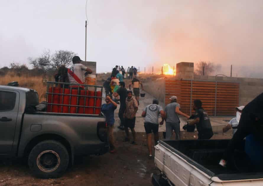 People attempt to control a fire at La Candelaria, in Córdoba province, Argentina