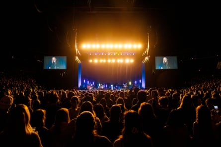 a crowd of people in front of a stage