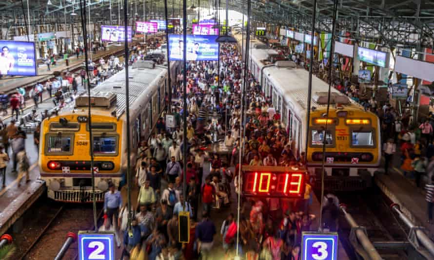 Workers get off a train at Churchgate station in Mumbai, India.
