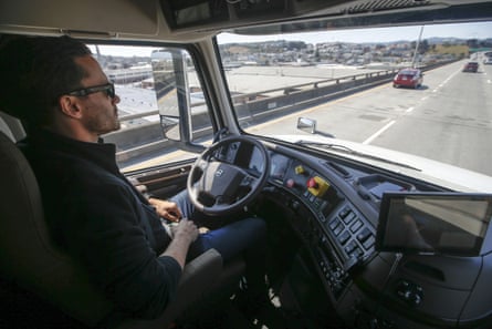 Matt Grigsby, senior program engineer at Otto, takes his hands off the steering wheel of a self-driving, big-rig truck during a demonstration on the highway, in San Francisco in 2016.