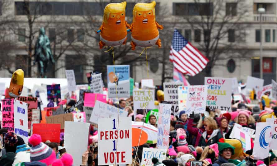 Baby Trump balloons float over thousands of people as they participate in the Women’s March at Freedom Plaza in Washington DC.