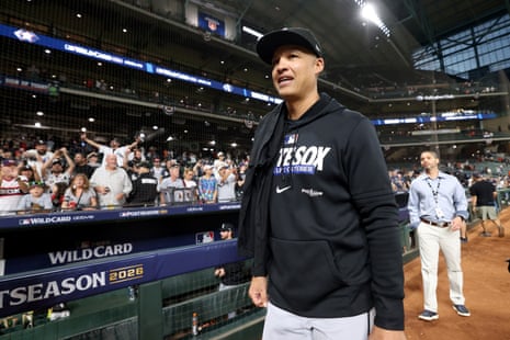 Manager Will Venable smiles while walking on the field as fans cheer behind him