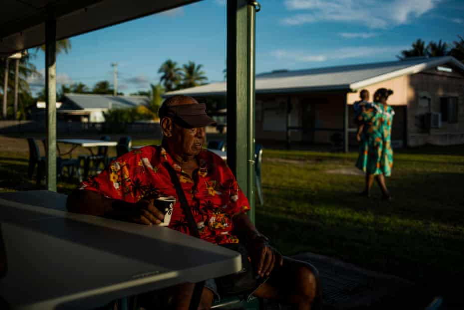 Voictor Nona, 80, a Badu Island elder, has a cup of coffee before a feast celebrating the tombstone revealing ceremony for his wife’s grave.